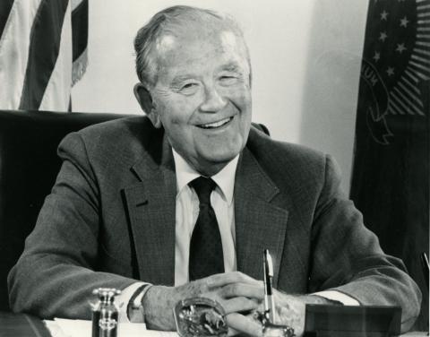 Quentin Burdick poses sitting down at a desk